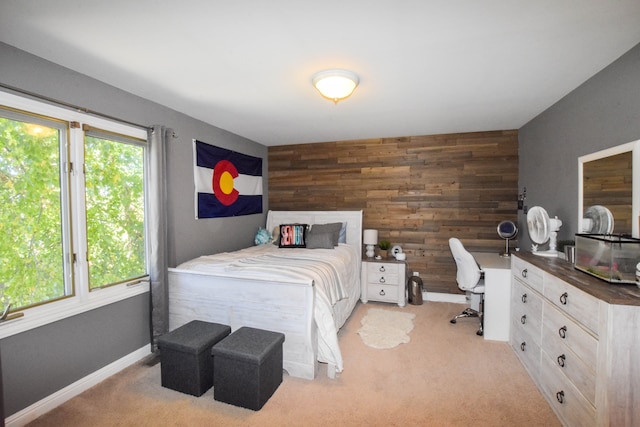 carpeted bedroom featuring wood walls