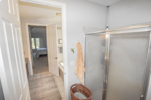 bathroom with tile patterned floors and a shower with shower door