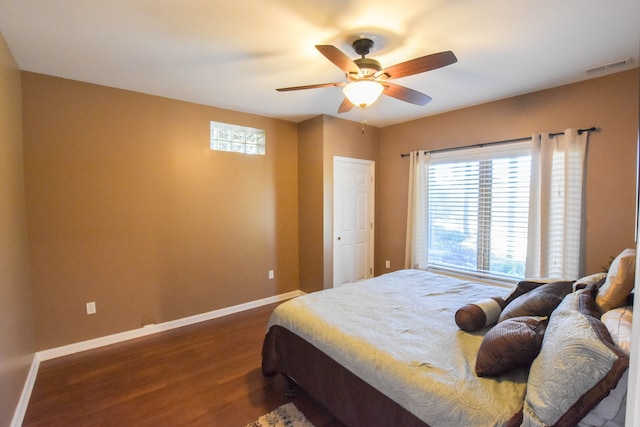 bedroom with ceiling fan and dark wood-type flooring