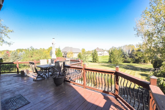 wooden terrace featuring a yard