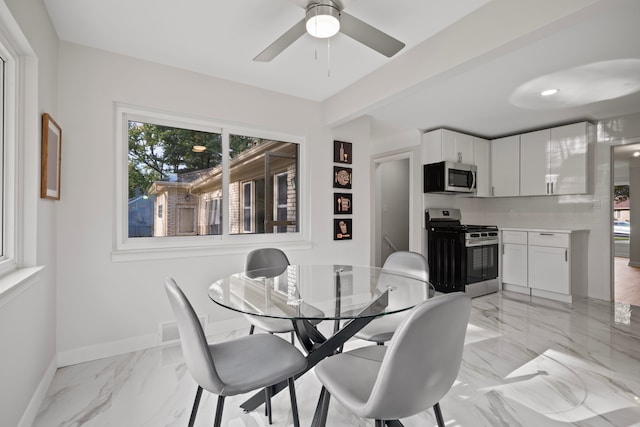 dining room with beamed ceiling and ceiling fan