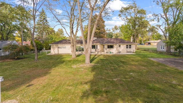 rear view of property with a yard and a patio