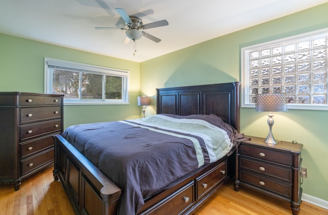 bedroom with light wood-type flooring and ceiling fan