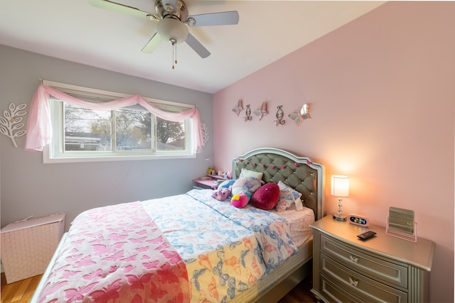 bedroom with radiator, ceiling fan, and wood-type flooring