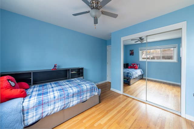 bedroom featuring hardwood / wood-style floors, ceiling fan, and a closet