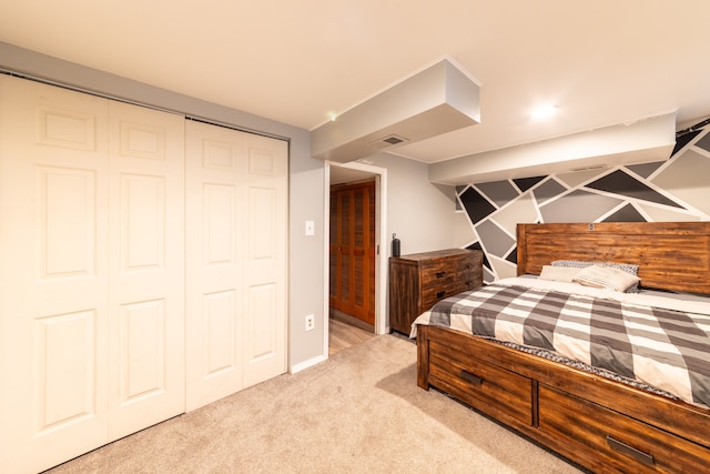 bedroom with light carpet and a closet