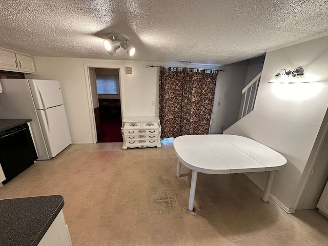 dining space with a textured ceiling