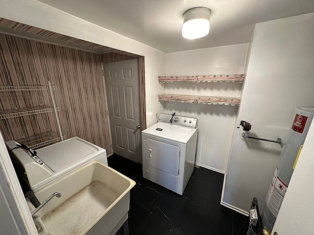 laundry area featuring sink, washer and clothes dryer, and water heater