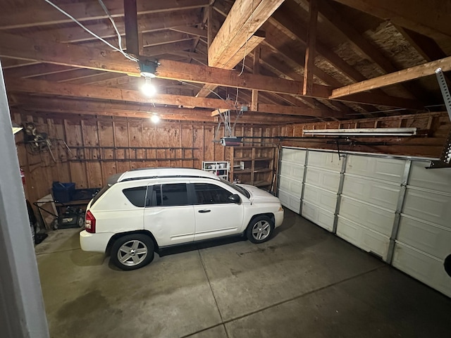 garage featuring wood walls