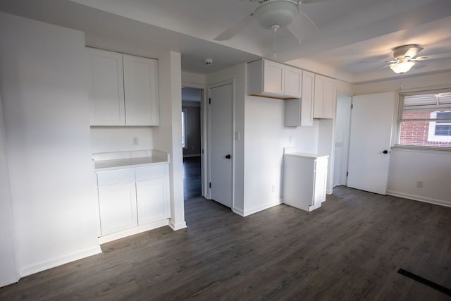 kitchen with ceiling fan, dark hardwood / wood-style flooring, and white cabinetry