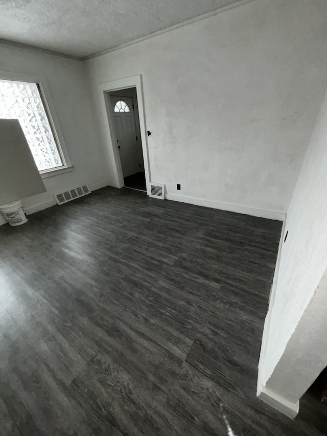 entrance foyer with dark hardwood / wood-style floors and a textured ceiling