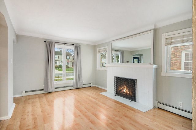 unfurnished living room featuring a baseboard radiator, hardwood / wood-style flooring, and ornamental molding