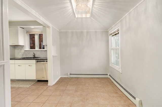 interior space with sink, lofted ceiling, and baseboard heating