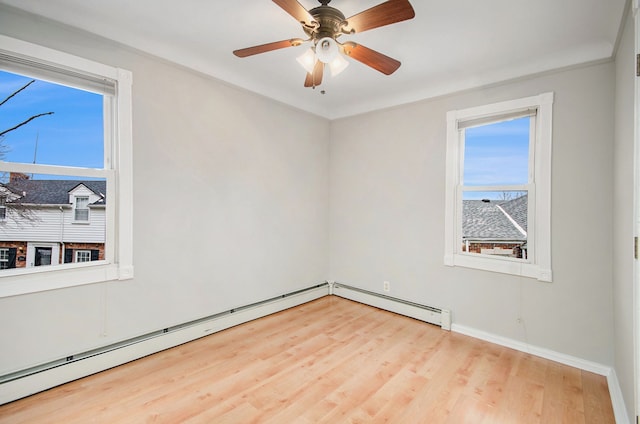 spare room featuring light hardwood / wood-style floors, a baseboard radiator, ceiling fan, and ornamental molding