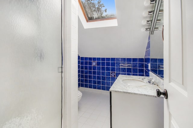 bathroom featuring tile patterned flooring, vanity, an enclosed shower, and lofted ceiling