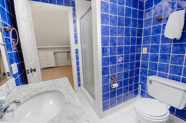 bathroom featuring toilet, an enclosed shower, and vanity