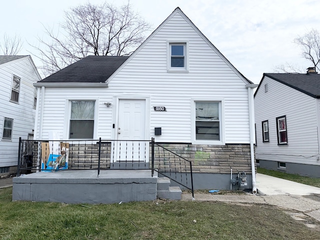 rear view of property with a lawn