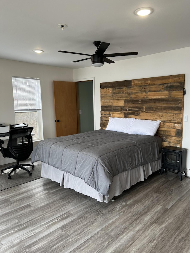 bedroom with hardwood / wood-style floors and ceiling fan