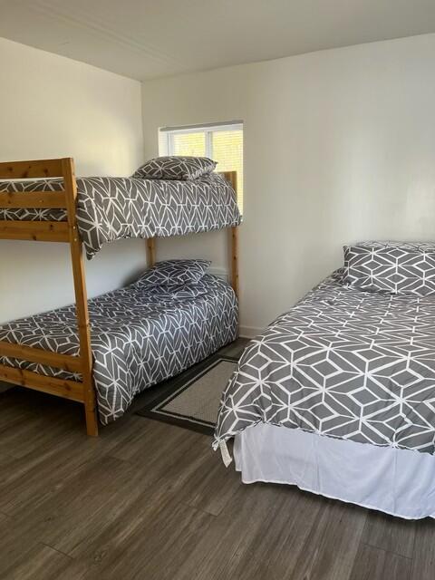 bedroom with hardwood / wood-style flooring