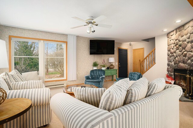 carpeted living room with ceiling fan, a fireplace, and a baseboard radiator