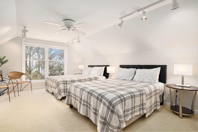 bedroom with light colored carpet, ceiling fan, and lofted ceiling