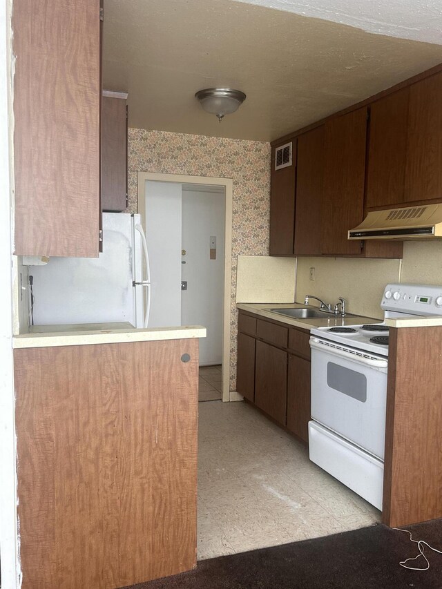 8900 E Jefferson Ave Unit 1229, Detroit, MI 48214 - kitchen with sink, white appliances, and exhaust hood