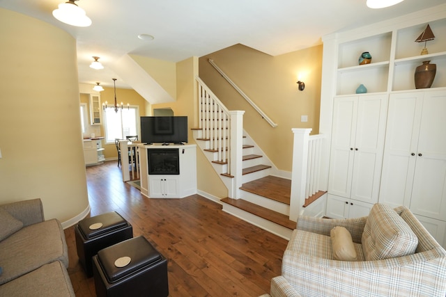 living room featuring a notable chandelier and dark hardwood / wood-style floors