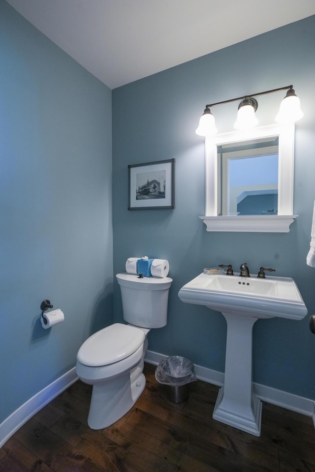 bathroom with hardwood / wood-style floors and toilet