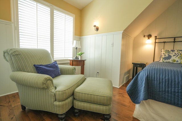 bedroom with dark hardwood / wood-style floors, vaulted ceiling, and multiple windows