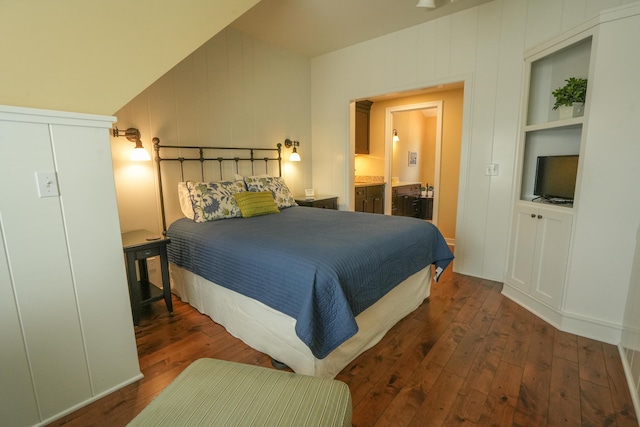 bedroom with dark hardwood / wood-style floors