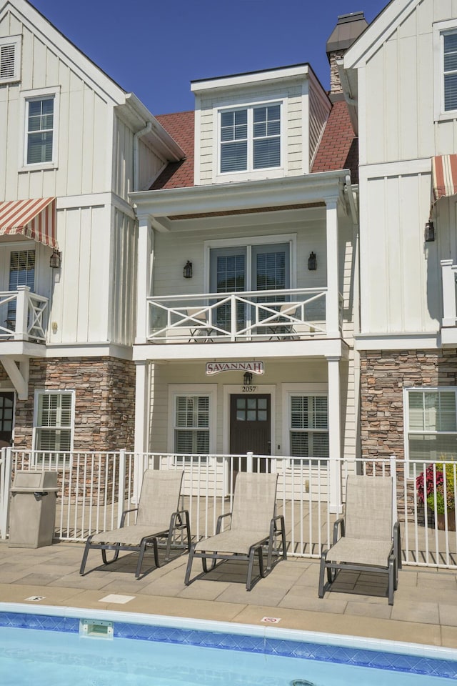 back of property featuring a patio area and a balcony