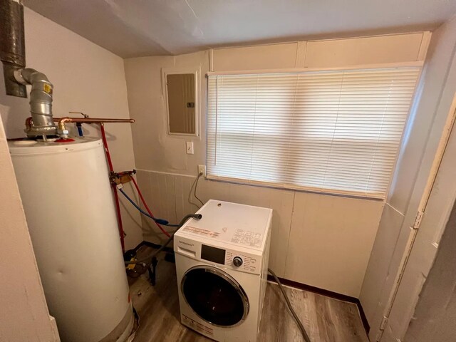 clothes washing area with gas water heater, electric panel, washer / clothes dryer, and hardwood / wood-style flooring