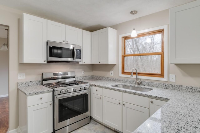 kitchen featuring white cabinetry, sink, and appliances with stainless steel finishes