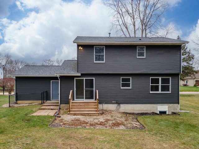 rear view of property with a lawn