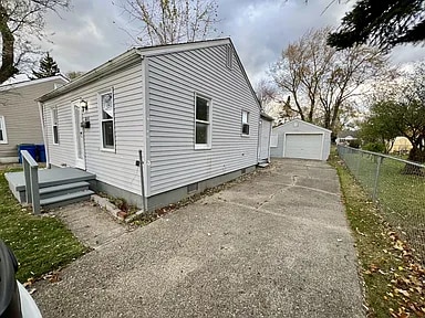 view of side of property with an outbuilding and a garage