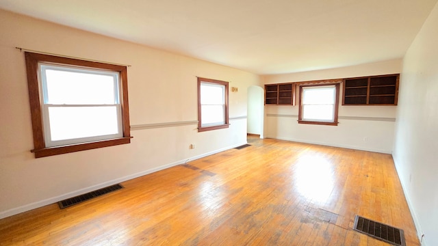 empty room with hardwood / wood-style flooring