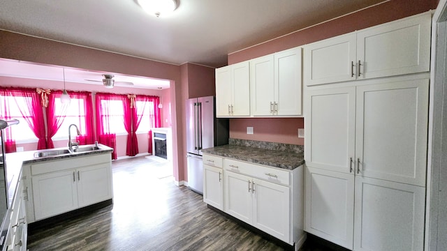 kitchen featuring white cabinetry, sink, and high end refrigerator