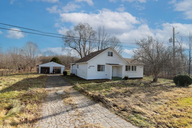 view of front facade featuring an outbuilding and a garage