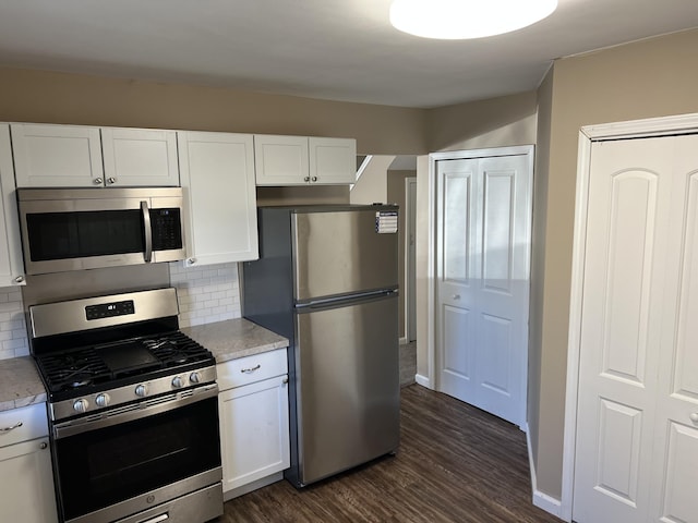 kitchen featuring white cabinets, appliances with stainless steel finishes, and backsplash