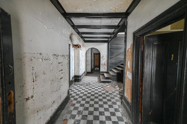 corridor featuring beam ceiling