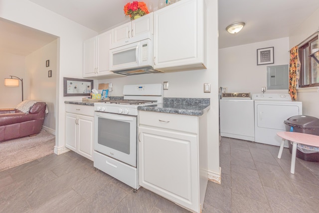 kitchen featuring white appliances, light tile patterned floors, white cabinets, washing machine and dryer, and electric panel