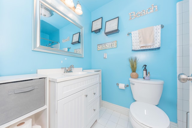 bathroom with tile patterned flooring, vanity, and toilet