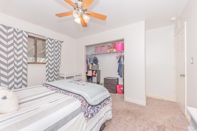 carpeted bedroom featuring ceiling fan and a closet