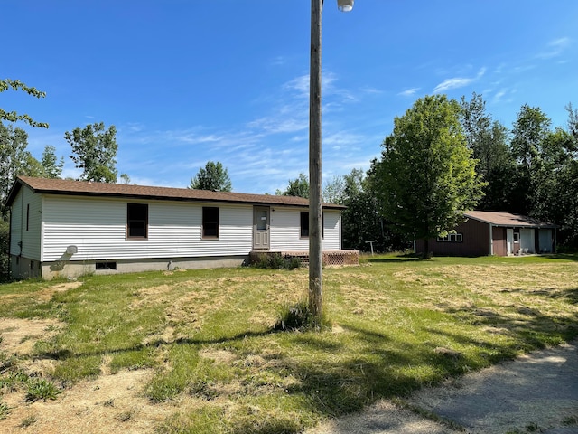 exterior space featuring a yard and an outbuilding