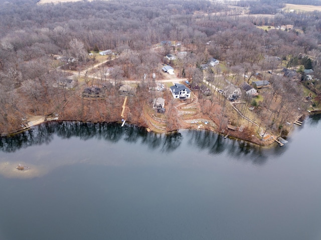 aerial view featuring a forest view and a water view