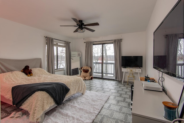 bedroom featuring access to outside, multiple windows, and a ceiling fan