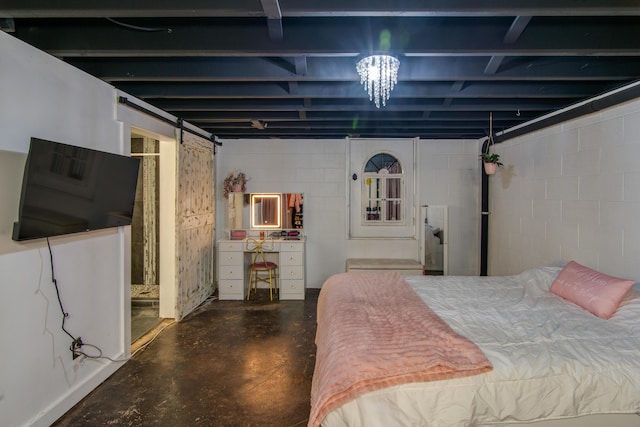 bedroom with concrete flooring, a barn door, and concrete block wall