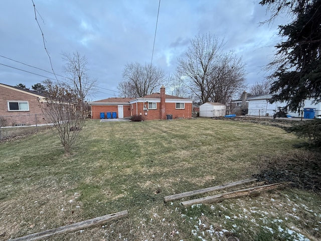 view of yard featuring an outbuilding and fence