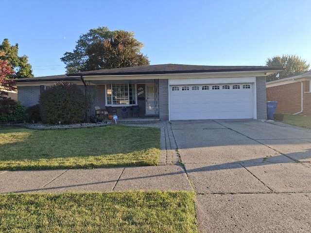 single story home with a porch, a garage, and a front yard