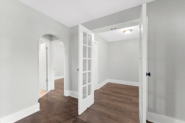 corridor with dark hardwood / wood-style flooring